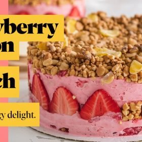 Delicious strawberry lemon crunch cake topped with fresh strawberries and a zesty lemon glaze.