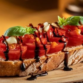 Beautifully decorated classic Italian bruschetta recipe with vibrant red tomatoes and green basil leaves on a toasted baguette base