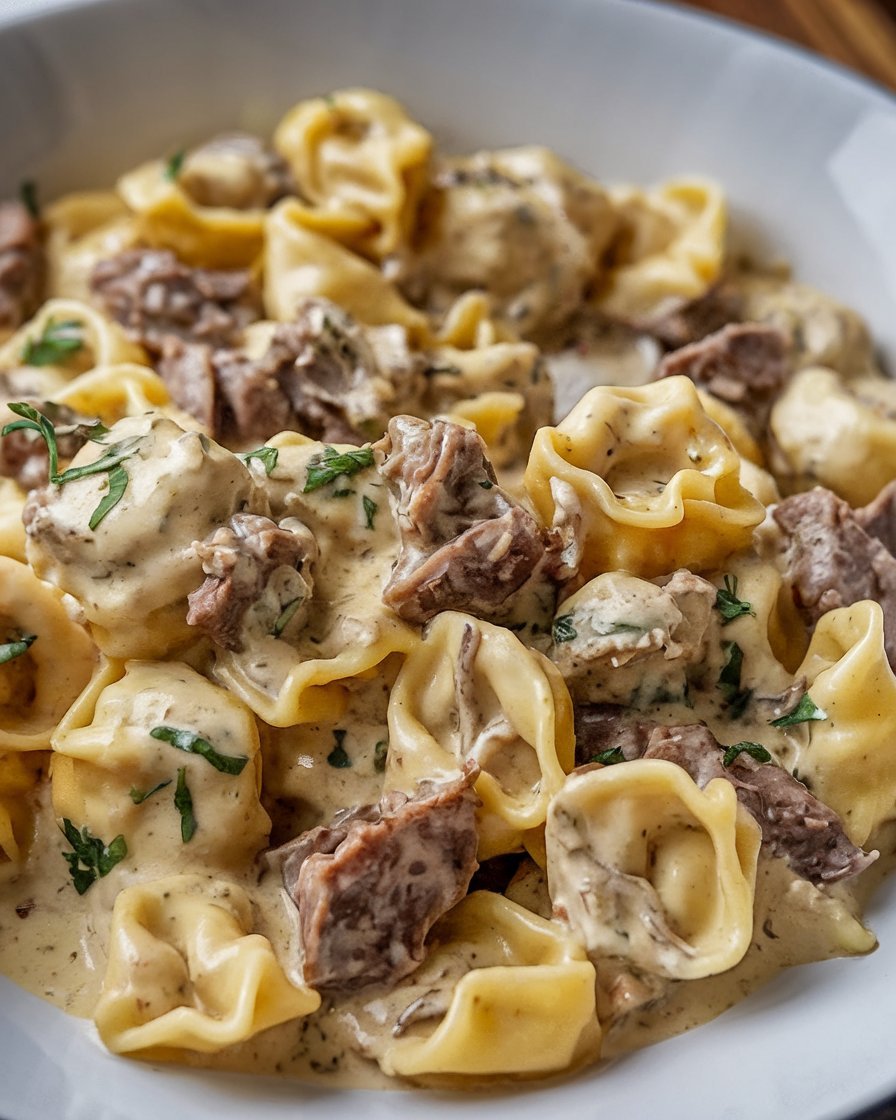 Delicious Philly Cheesesteak Tortellini Pasta with tender steak, sautéed onions, and a creamy cheese sauce